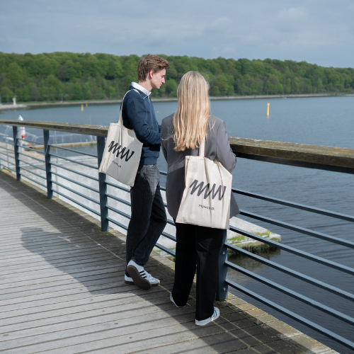 Ung mand og kvinde står ved havnen med myway-totebags